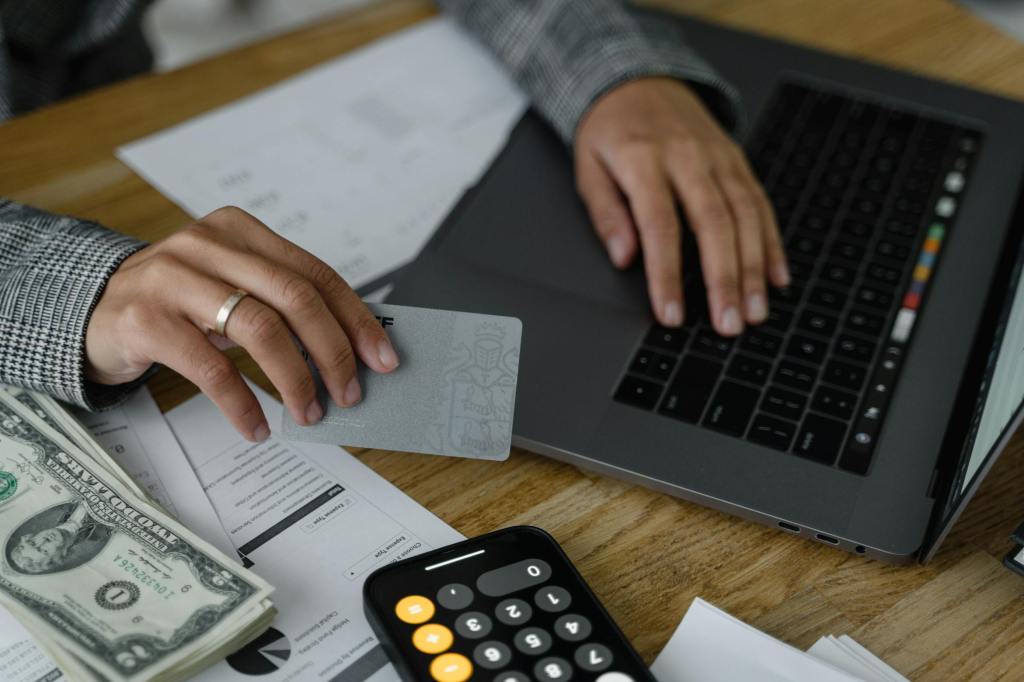 A person working on a laptop making full use of their Social Security Number